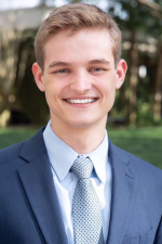 Portrait of student in suit smiling at camera